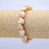 Pulsera elástica natural beige. Nácar facetado, diámetro 19×12 mm, longitud 18 cm+